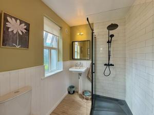 a bathroom with a shower and a sink at Cottage 493 - Clifden in Clifden +32 photos