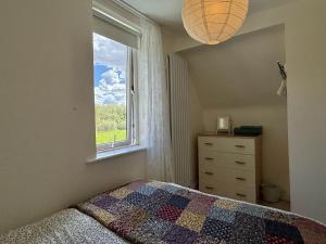 a bedroom with a bed and a window at Cottage 493 - Clifden in Clifden