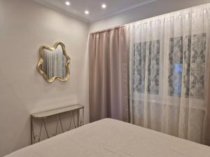 a bedroom with a bed and a mirror on the wall at Nektaria on the Beach in Fournoi