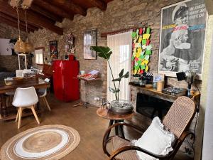 a living room with a fireplace and a red refrigerator at Cal David Estamariu in Estamariu