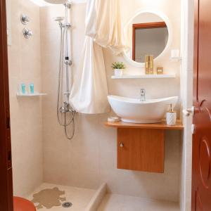a bathroom with a sink and a shower at Ιno Skiathos in Skiathos +103 photos