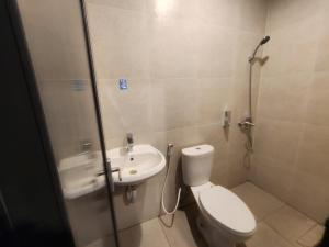 a small bathroom with a toilet and a sink at Sendja Residence in Semarang