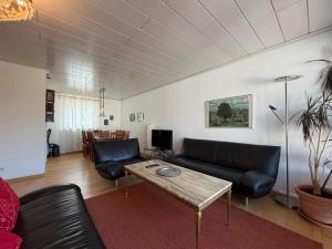 a living room with a couch and a table at Casa Calvin in Unteruhldingen