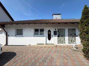 a white house with a fire hydrant in front of it at Casa Calvin in Unteruhldingen