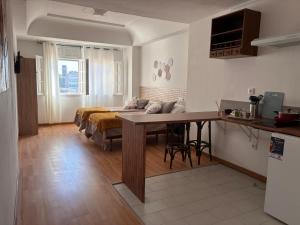 a living room with a bed and a table at La casa de la abuela in Narón