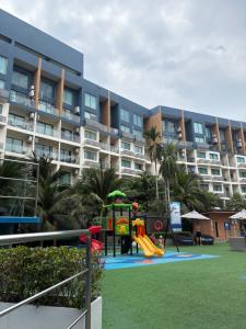 a playground in front of a large apartment building at Laguna Beach Resort 2 Pattaya in Jomtien Beach