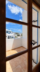 an open door with a view of a balcony at Azure Sea House in Avlemonas