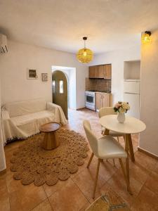 a living room with a couch and a table at Azure Sea House in Avlemonas