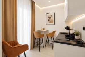 a kitchen with chairs and a table in a room at Apartmani Centar in Igalo