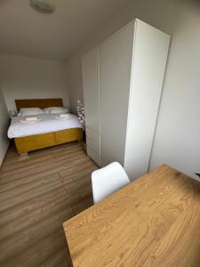 a small bedroom with a bed and a desk at Apartmán Třinec in Třinec