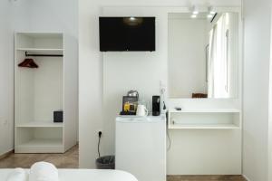 a kitchen with a white refrigerator and a mirror at Argo Rooms-Papadakis in Kissamos +109 photos