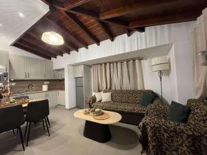 a living room with a couch and a table at Angie Apartment in Ierissos +7 photos