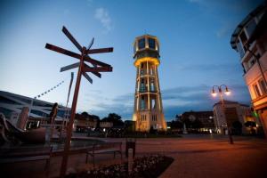 a clock tower in the middle of a city at City Hotel Siófok in Siófok