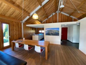 a kitchen and dining room with a wooden table and chairs at Sonnenchalet in Bodman-Ludwigshafen