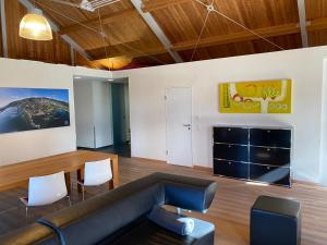 a living room with a couch and a table and chairs at Sonnenchalet in Bodman-Ludwigshafen