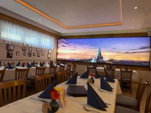a conference room with tables and a large screen at Heimatblick Fulda in Fulda