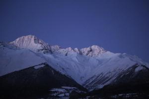 a group of snow covered mountains in the distance at Ninama in Mestia