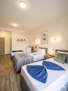 a hotel room with three beds with blue sheets at Park Plaza Haven in Cairo