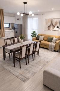 a dining room and living room with a table and chairs at Casa Mara in Ideciu de Jos