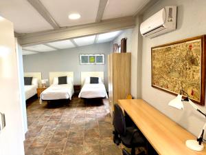 a room with two beds and a desk in it at Mas de la Maria in Cambrils +55 photos