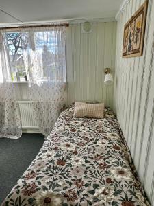 a bedroom with a large bed with a floral blanket at Nordic Quiet Stay in Falun