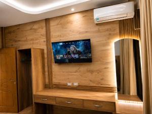 a room with a tv on a wooden wall at Flogeri in Vlorë +8 photos