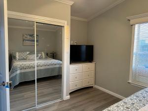 a bedroom with a bed and a flat screen tv at Lake Front, Beach Retreat in Fort Myers Beach +19 photos