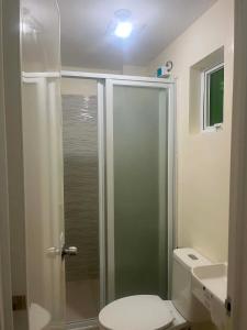 a bathroom with a shower with a toilet and a sink at Hidalgo Lodge in Santa Ana