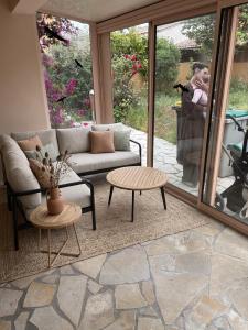 a woman taking a picture of a living room at Bienvenue au soleil in Sainte-Marie-la-Mer