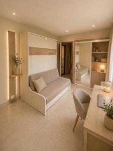a living room with a couch and a chair at Bienvenue au soleil in Sainte-Marie-la-Mer