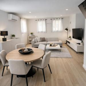 a living room with a table and a couch at Bienvenue au soleil in Sainte-Marie-la-Mer
