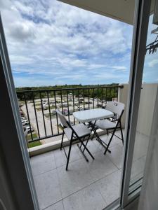 a balcony with a table and chairs and a view at AR's Staycation in Lapu Lapu City