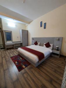 a bedroom with a large bed in a room at pristine mountain lodge in Chail