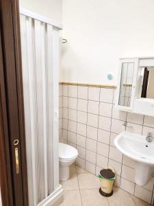 a bathroom with a toilet and a sink at HOUSE IN PARADISE - Realmonte with Free parking in Realmonte +2 photos