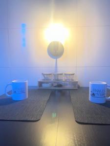 two coffee mugs sitting on top of a table at Chale Azul Aconchegante com lareira no bosque e estacionamento grátis in Extrema +15 photos