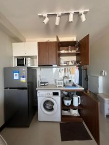 a kitchen with a washing machine and a dishwasher at AR's Staycation in Lapu Lapu City