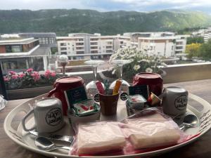 a plate of food on a table with a view at Chambre vue parc chez l'habitant in Annecy