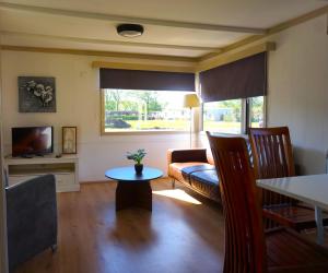 a living room with a couch and a table at 't Veldhuisje 110 - naast het bos, honden toegestaan in Anloo