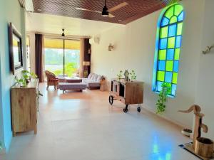 a living room with a couch and stained glass windows at Eternal Bliss By Ganga Blessing in Rishīkesh