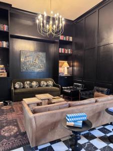 a living room with a couch and a chandelier at Salt Ranch Hotel in Nashville