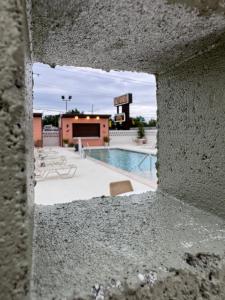 a view of a swimming pool through a hole in a wall at Salt Ranch Hotel in Nashville