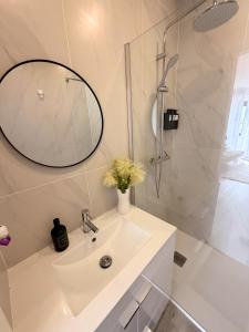a white bathroom with a sink and a shower at Naval - Marina View Apartments in Vila do Conde +32 photos