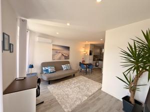 a living room with a couch and a table at Naval - Marina View Apartments in Vila do Conde