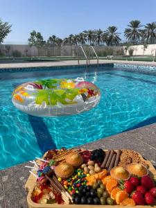 a tray of food next to a swimming pool at Rovana Chalet in Barka +10 photos