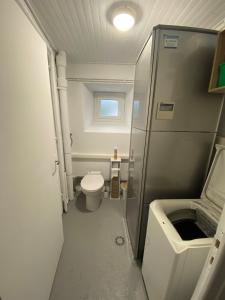 a small bathroom with a toilet and a sink at Maison typique auvergnate in Saint-Jacques-des-Blats