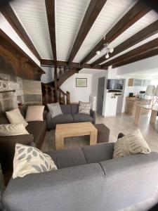 a living room with a couch and a table at Maison typique auvergnate in Saint-Jacques-des-Blats