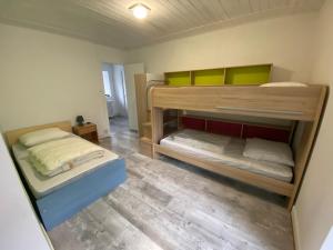 a room with two bunk beds in it at Maison typique auvergnate in Saint-Jacques-des-Blats