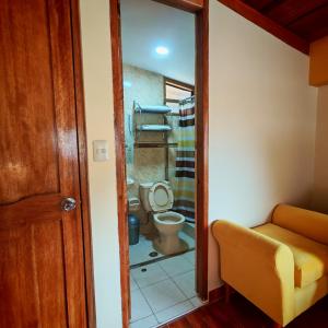 a bathroom with a toilet and a glass door at Sunshine in Ollantaytambo +56 photos