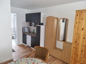 a kitchen with a refrigerator and a table in a room at Ferienwohnung Pasewalk Zentrum in Pasewalk