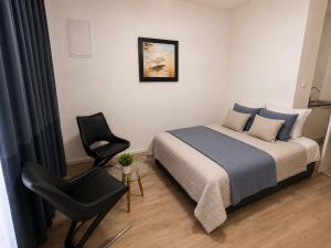 a bedroom with a bed and a chair at Perello Old Town in Split